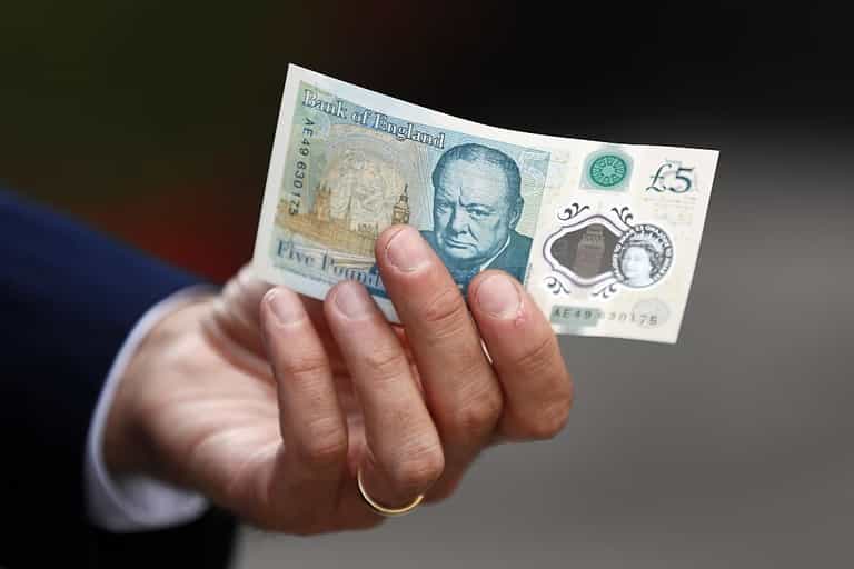 Bags of cash fall from security truck with dozens of people picking up £225,000