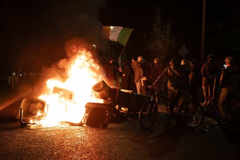 Police van set on fire and one officer injured after ‘violent’ protest in Ireland