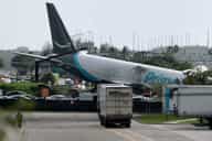 Major US airport shut down after Amazon cargo plane overshoots runway hitting multiple vehicles