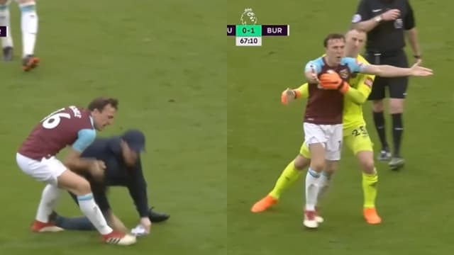 Mark Noble throws West Ham supporter to the ground during pitch invasion