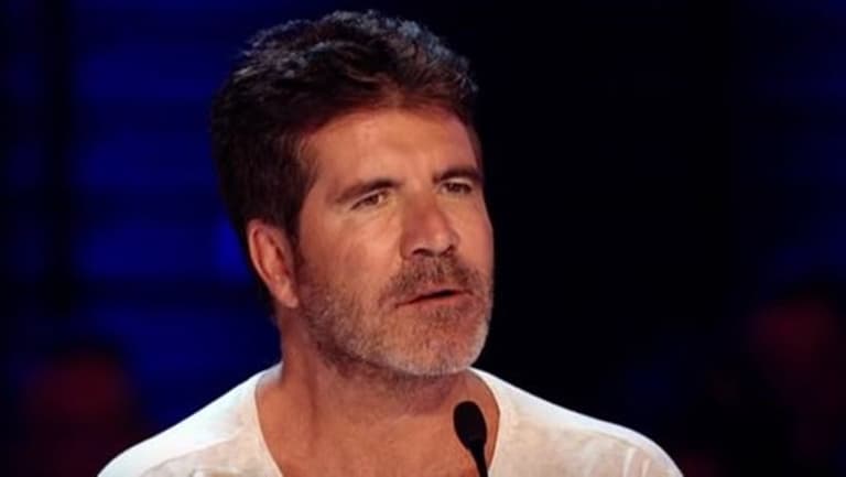 Audience left in shock after Simon Cowell is set on fire by masked contestant Audience left in shock after Simon Cowell is set on fire by masked contestant