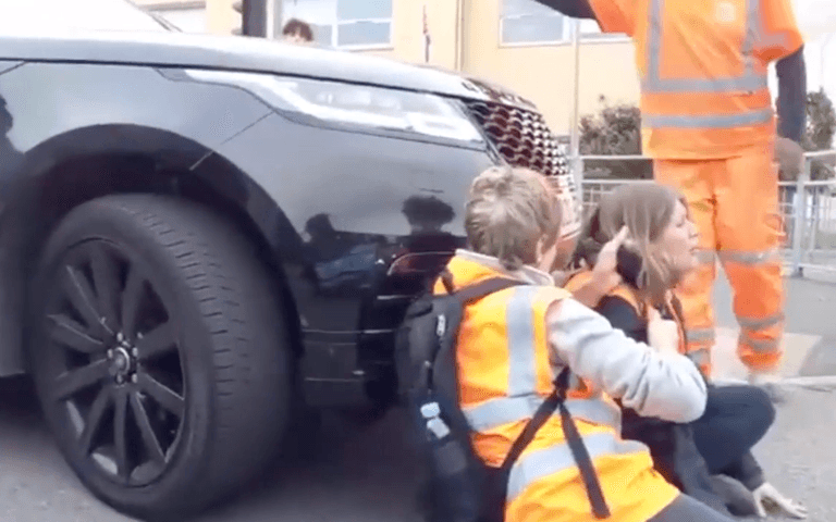 Woman starts driving over Insulate Britain protestor in furious standoff Woman starts driving over Insulate Britain protestor in furious standoff