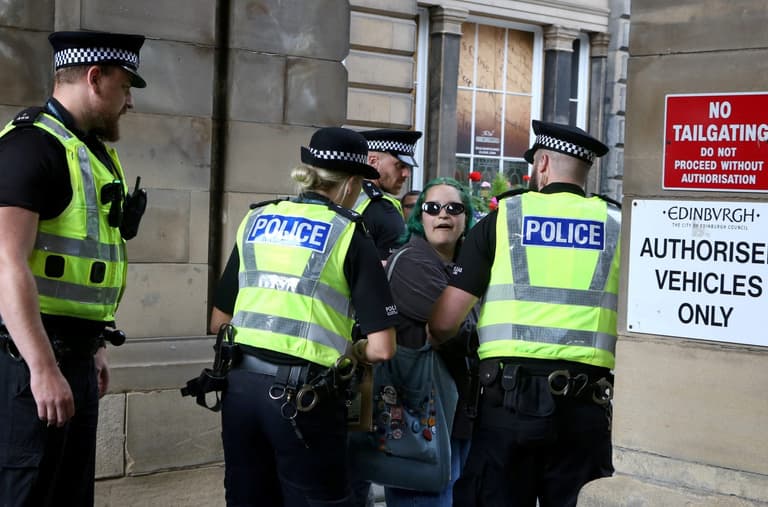 Woman with ‘abolish monarchy’ sign charged with offence after arrests of republican protesters Woman with ‘abolish monarchy’ sign charged with offence after arrests of republican protesters