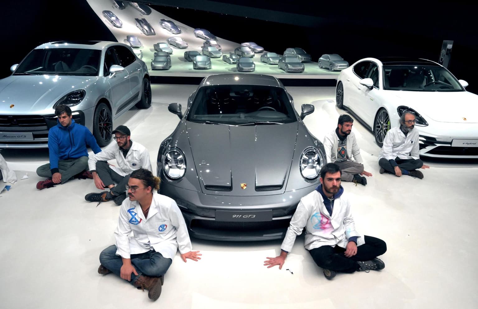 Climate activists glue themselves to floor of car dealership – but complain when staff turn off the lights and go home