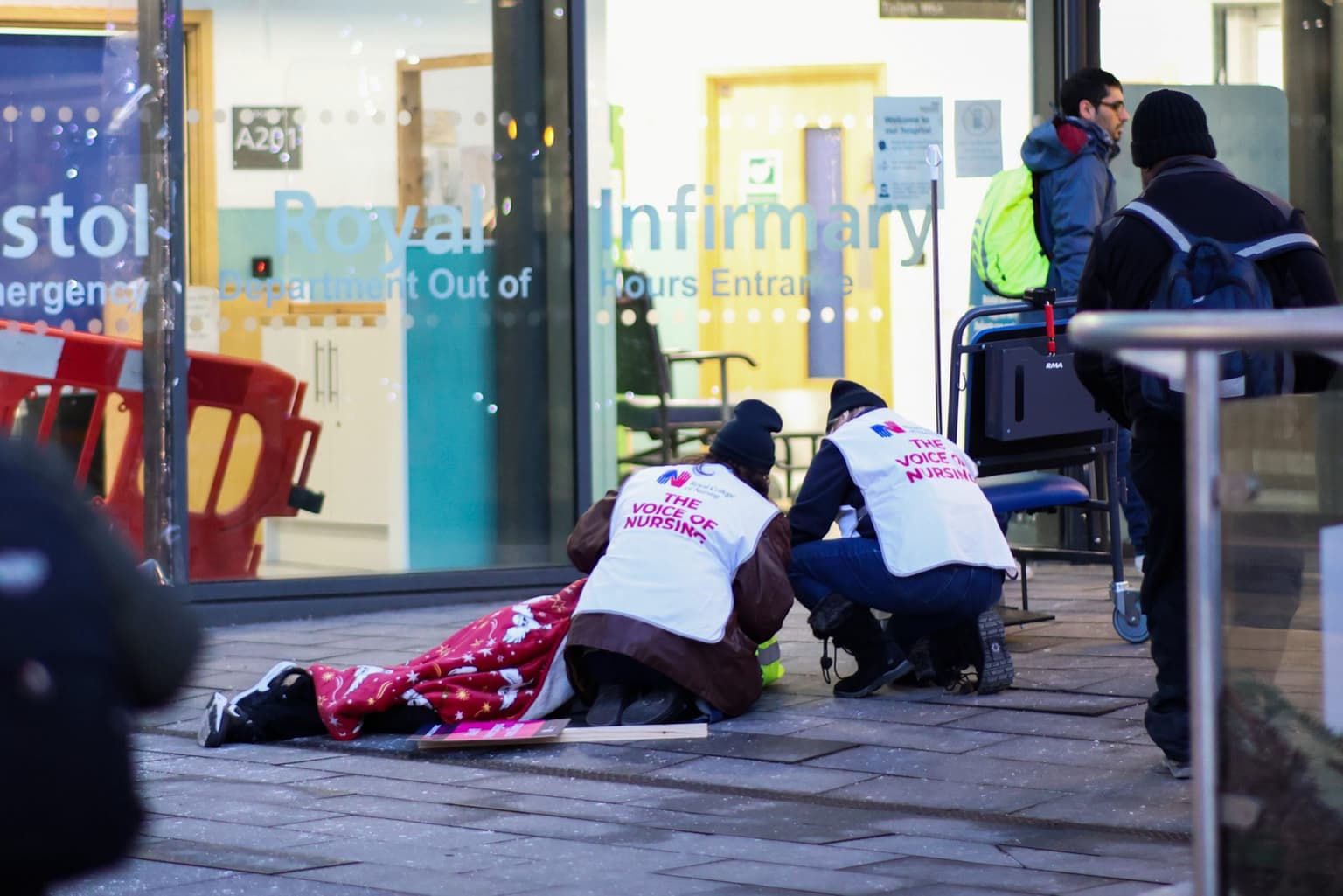 Striking nurses break picket line to help man who had collapsed