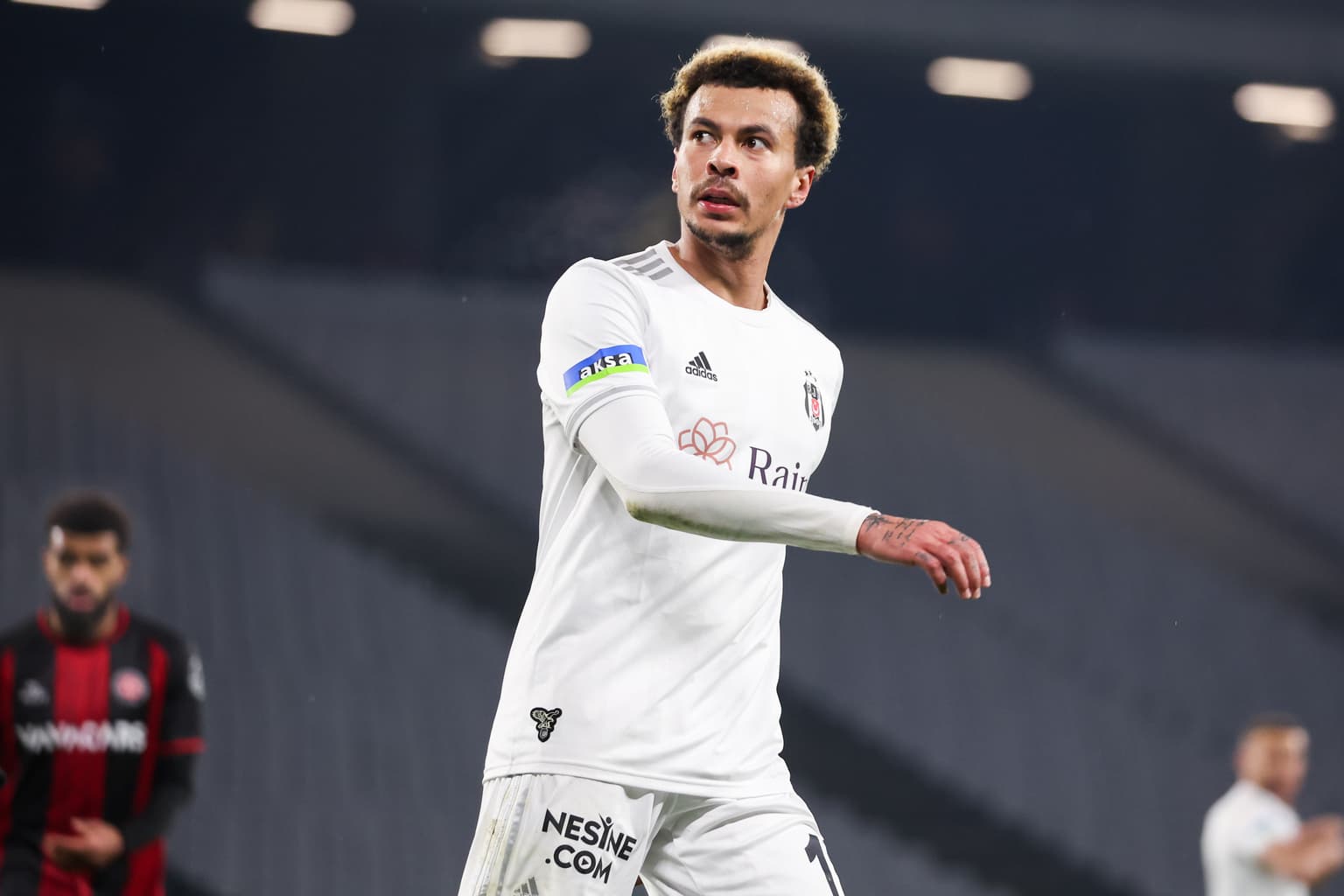 Dele Alli pictured surrounded by gas canisters with balloon in his mouth