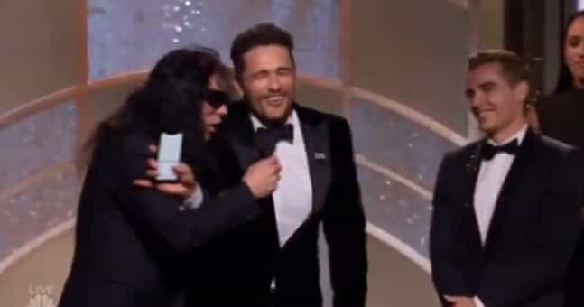 Tommy Wiseau tries to grab the microphone after James Franco’s win Tommy Wiseau tries to grab the microphone after James Franco’s win