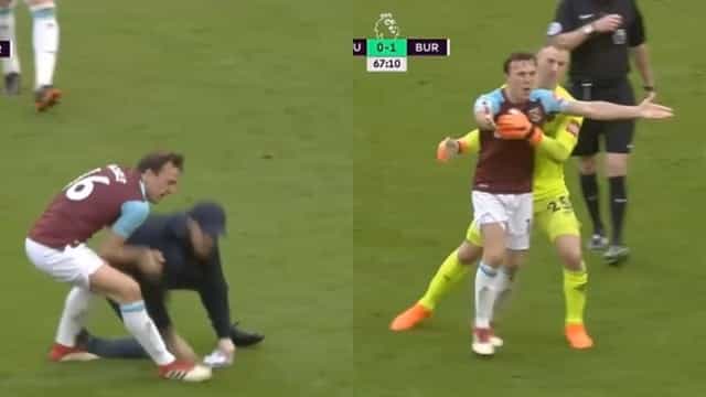 Mark Noble throws West Ham supporter to the ground during pitch invasion Mark Noble throws West Ham supporter to the ground during pitch invasion