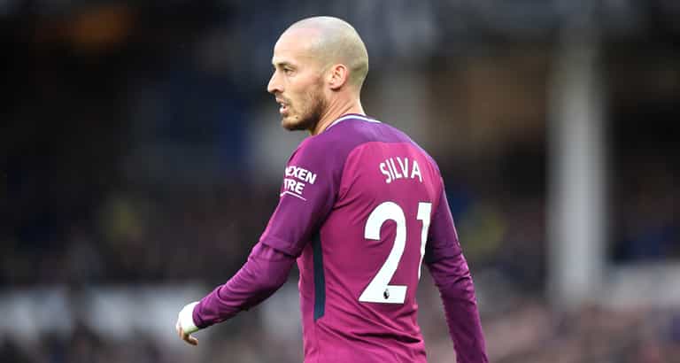 David Silva celebrates winning the title with his baby son David Silva celebrates winning the title with his baby son