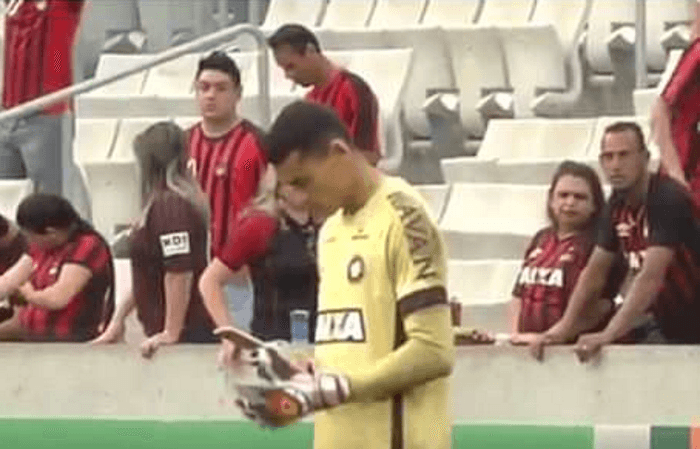 Brazilian goalkeeper checks his phone during league top flight match Brazilian goalkeeper checks his phone during league top flight match