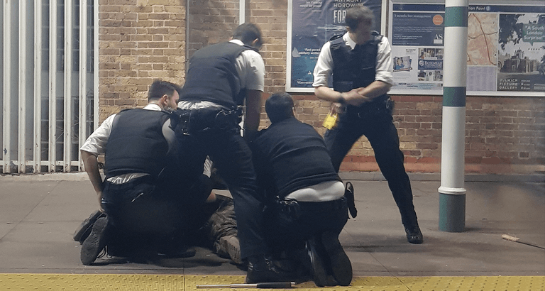 Police taser man with machete at London train station Police taser man with machete at London train station