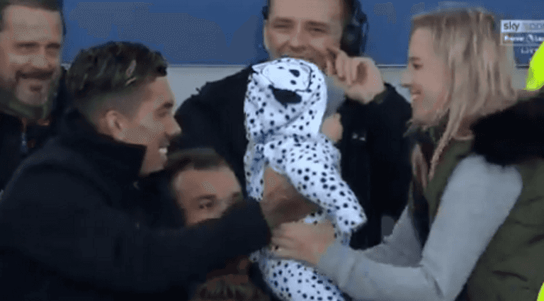 Roberto Firmino poses for picture with baby during Merseyside Derby Roberto Firmino poses for picture with baby during Merseyside Derby