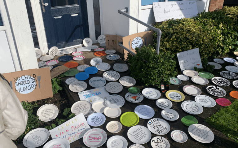 Empty plates left outside Tory office in protest of free school meals vote Empty plates left outside Tory office in protest of free school meals vote