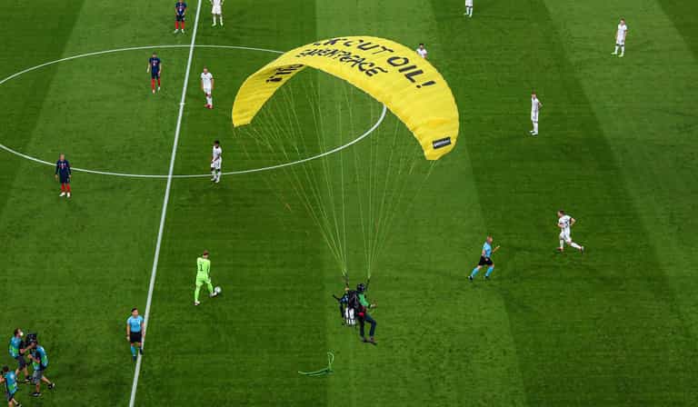 Greenpeace protestor almost parachutes into crowd at Germany vs France game Greenpeace protestor almost parachutes into crowd at Germany vs France game