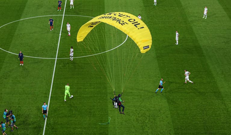 Greenpeace protestor almost parachutes into crowd at Germany vs France game Greenpeace protestor almost parachutes into crowd at Germany vs France game