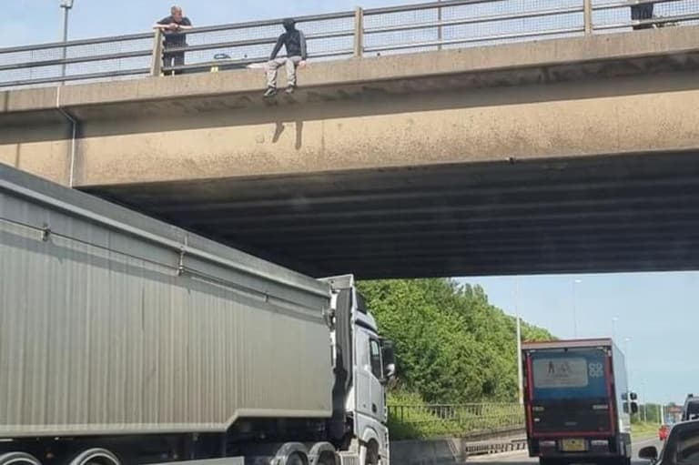 Truck driver saves man by parking under M62 to stop him jumping Truck driver saves man by parking under M62 to stop him jumping