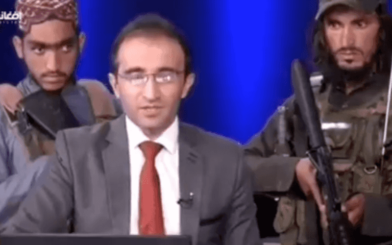 Shocking footage shows reporter read the news surrounded by armed Taliban Shocking footage shows reporter read the news surrounded by armed Taliban