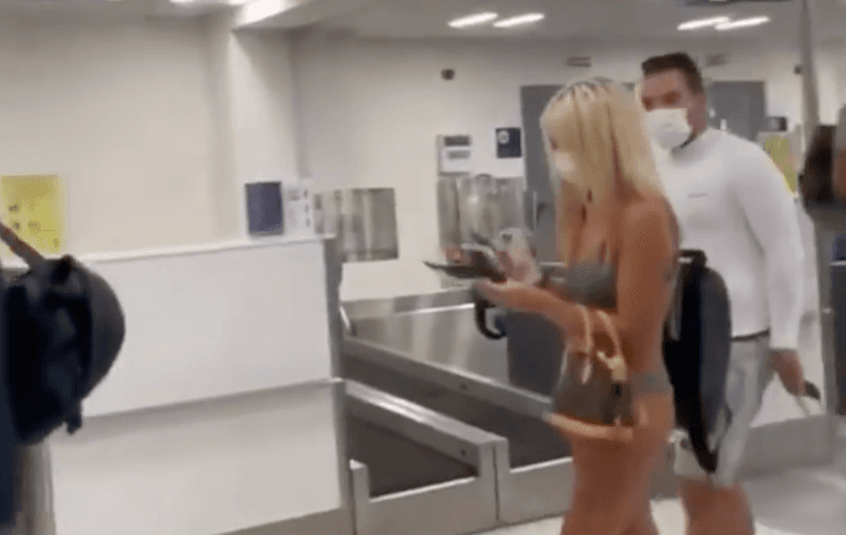Woman walks through airport wearing just bikini – and a face mask Woman walks through airport wearing just bikini – and a face mask
