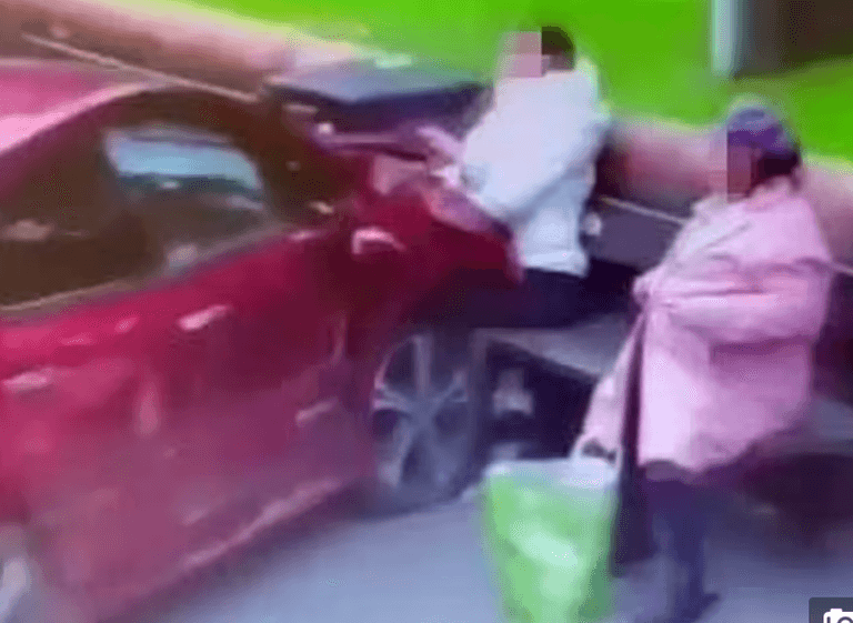 Shocking moment woman smoking on park bench slammed into by car Shocking moment woman smoking on park bench slammed into by car