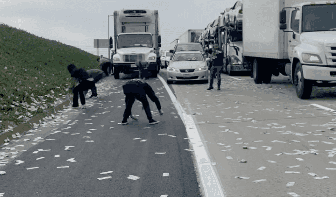 Armoured truck spills money across motorway as drivers go wild in cash grab Armoured truck spills money across motorway as drivers go wild in cash grab