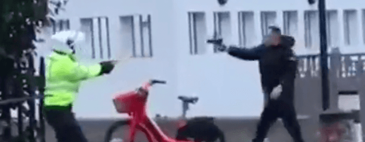 Terrifying video captures moment man pulls pistol on police officer during tense standoff Terrifying video captures moment man pulls pistol on police officer during tense standoff