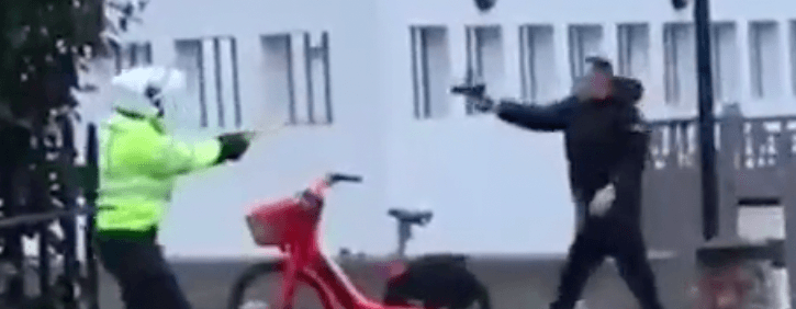 Terrifying video captures moment man pulls pistol on police officer during tense standoff Terrifying video captures moment man pulls pistol on police officer during tense standoff