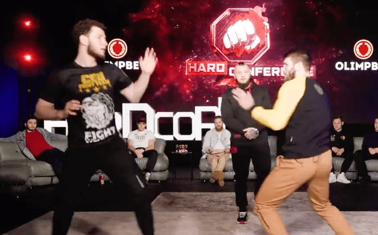 MMA fighter punches opponent during face-off at press conference MMA fighter punches opponent during face-off at press conference