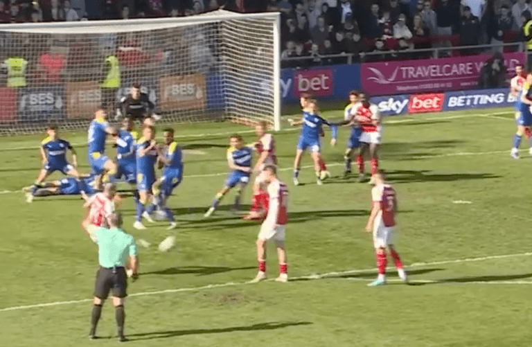 Wimbledon concede bizarre equaliser after ‘keeper gives away idiotic free kick Wimbledon concede bizarre equaliser after ‘keeper gives away idiotic free kick