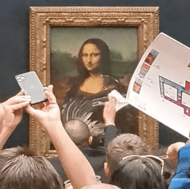 Man ‘dressed as old lady in wheelchair attacks Mona Lisa with cake in bizarre climate protest Man ‘dressed as old lady in wheelchair attacks Mona Lisa with cake in bizarre climate protest