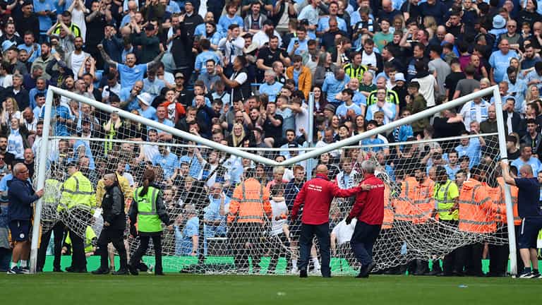 Man City fans break crossbar during pitch invasion Man City fans break crossbar during pitch invasion