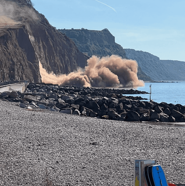 Dramatic moment cliff collapses on UK beach as hot weather scorches rocks Dramatic moment cliff collapses on UK beach as hot weather scorches rocks