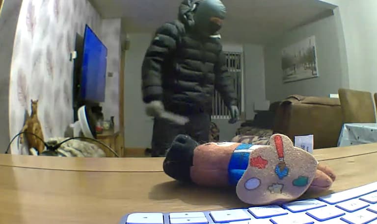 Chilling moment man with knife and balaclava is captured wandering around family’s living room Chilling moment man with knife and balaclava is captured wandering around family’s living room