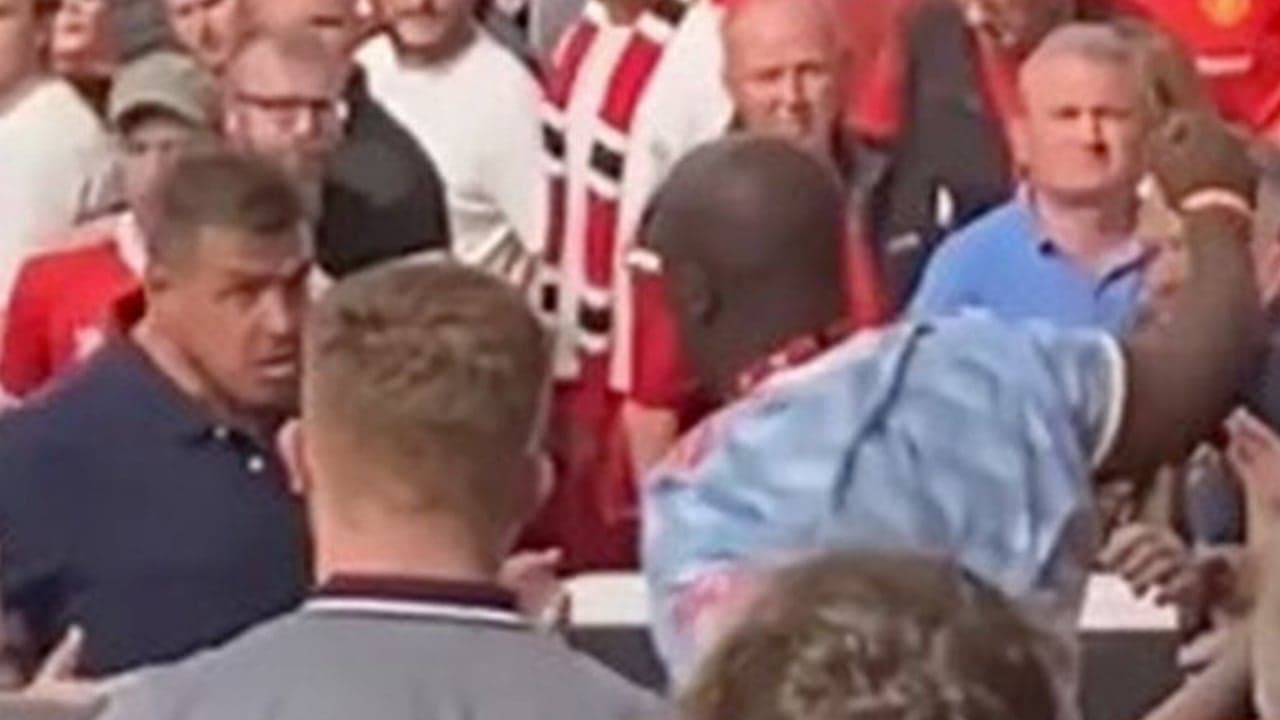 Manchester United fans fight each other in the stands during Brighton defeat