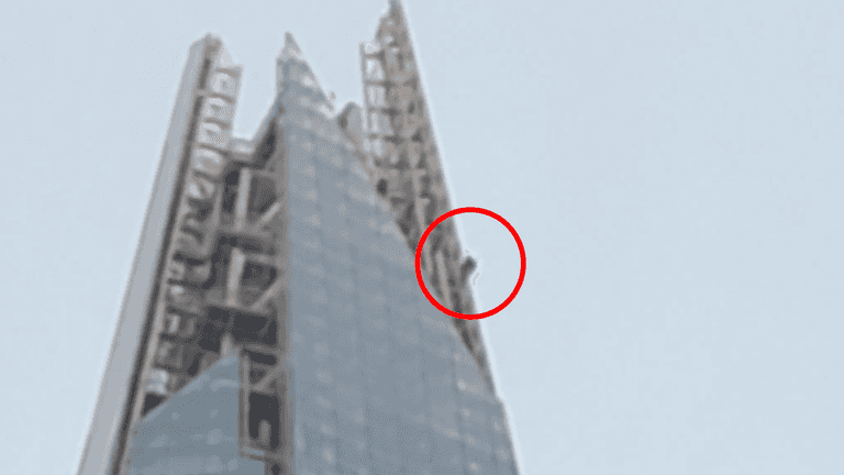 Topless man spotted free climbing to the top of The Shard Topless man spotted free climbing to the top of The Shard