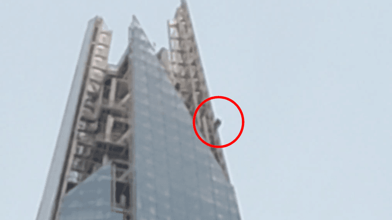 Topless man spotted free climbing to the top of The Shard Topless man spotted free climbing to the top of The Shard