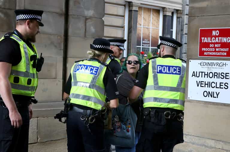 Woman with ‘abolish monarchy’ sign charged with offence after arrests of republican protesters Woman with ‘abolish monarchy’ sign charged with offence after arrests of republican protesters