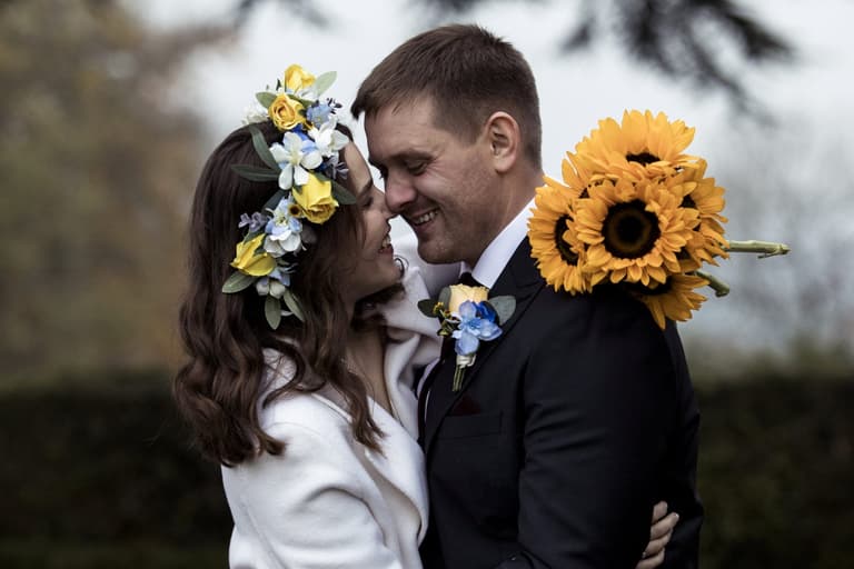 Ukrainian couple marry in the UK surrounded by pictures of their family Ukrainian couple marry in the UK surrounded by pictures of their family