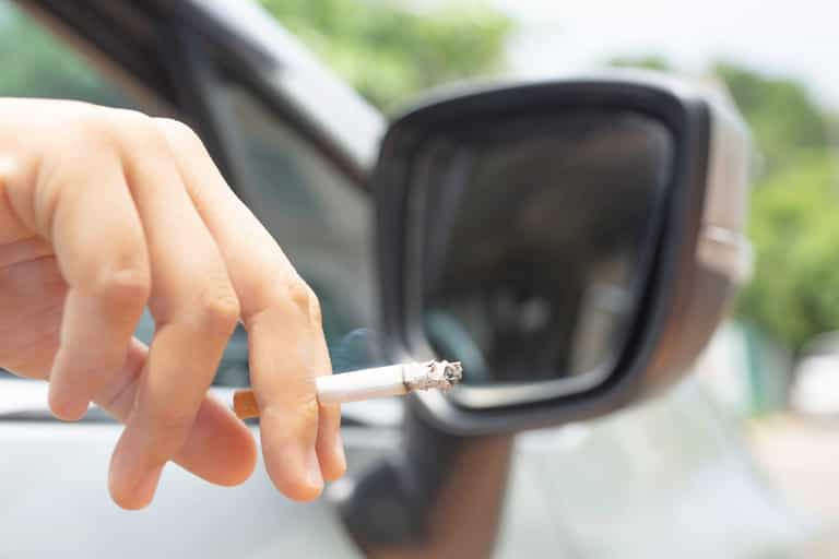 Woman fined £1,500 for flicking cigarette from car window Woman fined £1,500 for flicking cigarette from car window