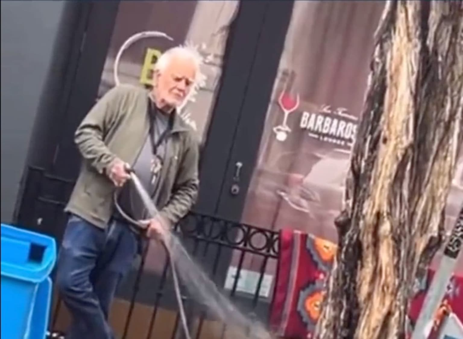 Gallery owner arrested after he was filmed spraying homeless woman with hose
