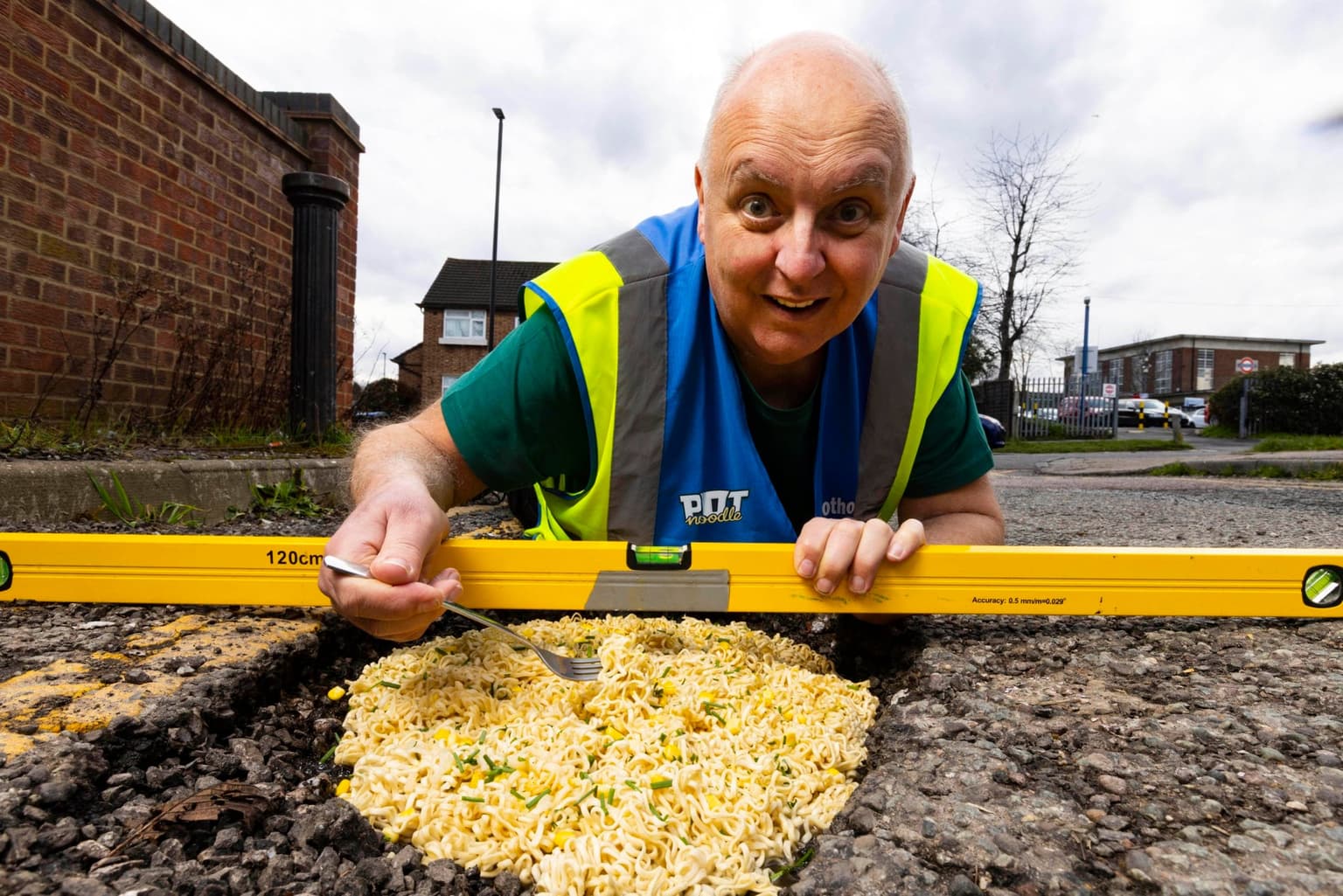 Man fills potholes with pot noodles to highlight state of UK roads