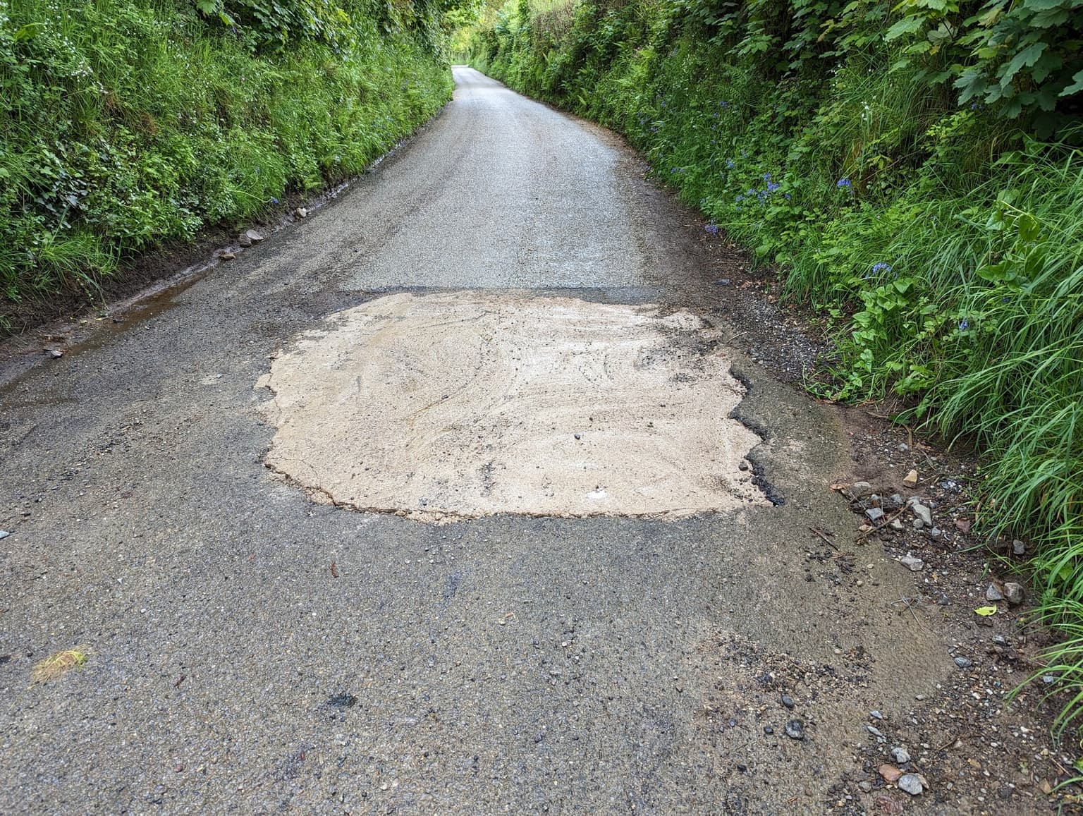 Officials search for mystery motorist who filled huge pothole with concrete