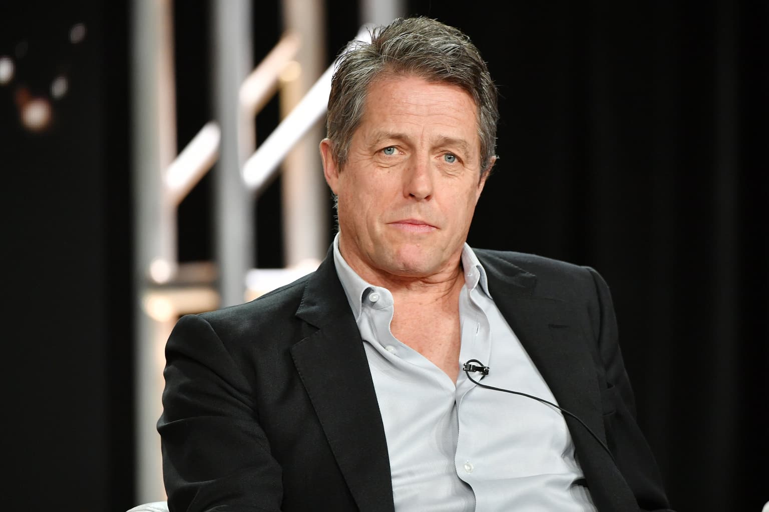 Hugh Grant says he’s happiest when ‘drinking a pint, eating Twiglets and reading about a Colin Firth box office catastrophe’