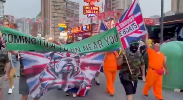 Beyond parody! Brits in Benidorm wave anti-immigration banners during parade Beyond parody! Brits in Benidorm wave anti-immigration banners during parade