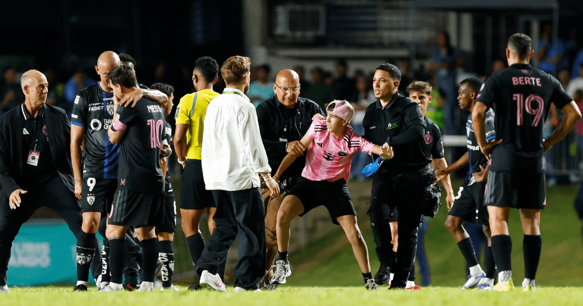 Lionel Messi taken down by pitch invader as player forced to intervene