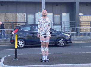 Semi-naked groom taped to traffic light in hilarious stag do prank