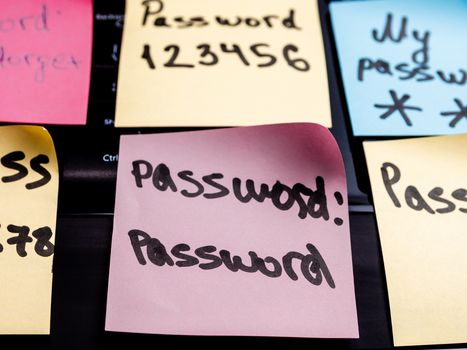 Close up of sticky notes with weak passwords and over computer keyboard. The scene is situated in a studio environment. The picture is taken with Panasonic GH5 camera.