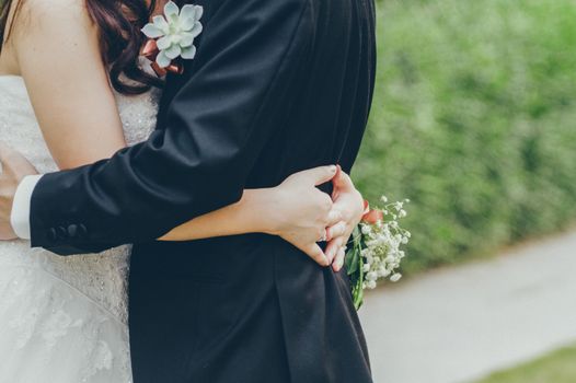 Husband and wife hugging at their wedding