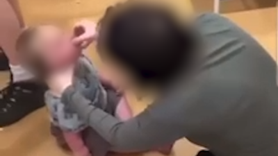 Man and woman arrested after footage appears to show baby given shot of vodka