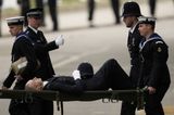 Police officer collapses and carried away on stretcher during Queen’s funeral