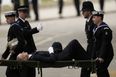 Police officer collapses and carried away on stretcher during Queen’s funeral